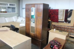 A mirror fronted single door wardrobe fitted with