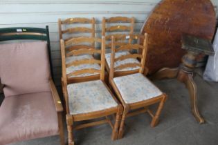 A set of four ladder back dining chairs