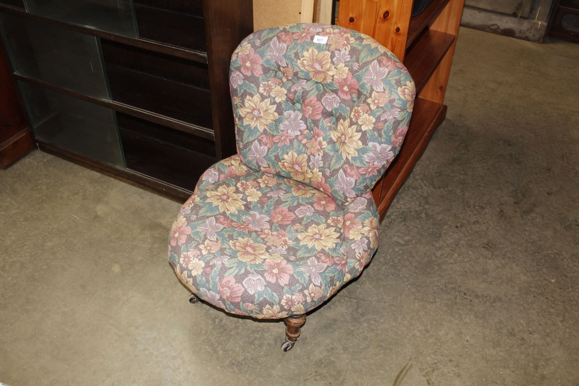 An upholstered button back nursing chair