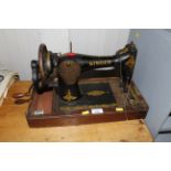 A Singer hand sewing machine lacking case