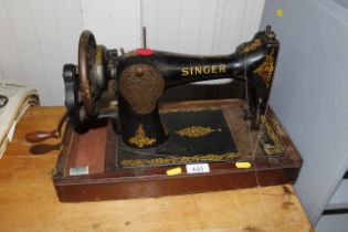 A Singer hand sewing machine lacking case