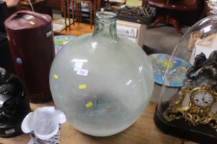 A glass carboy and contents of marbles