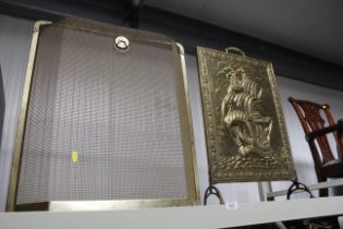 An embossed brass fireguard in the form of a Naval