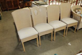 A set of four Lloyd Loom dining room chairs (some stained)
