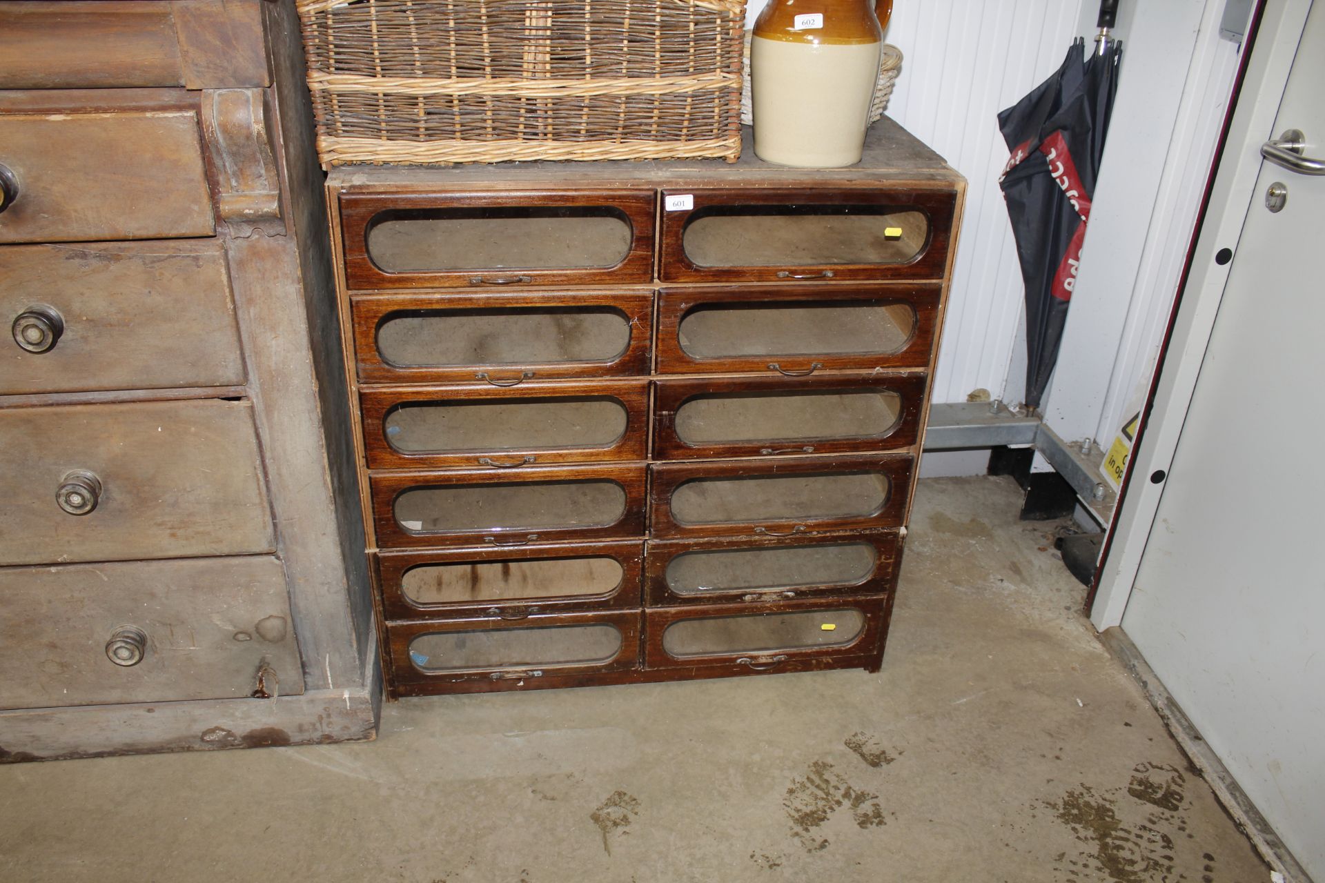A haberdashery cabinet fitted twelve partly glazed fronted drawers AF