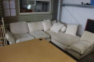 A cream upholstered corner sofa