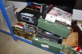 Four boxes of various VHS tapes, CDs, a case set o