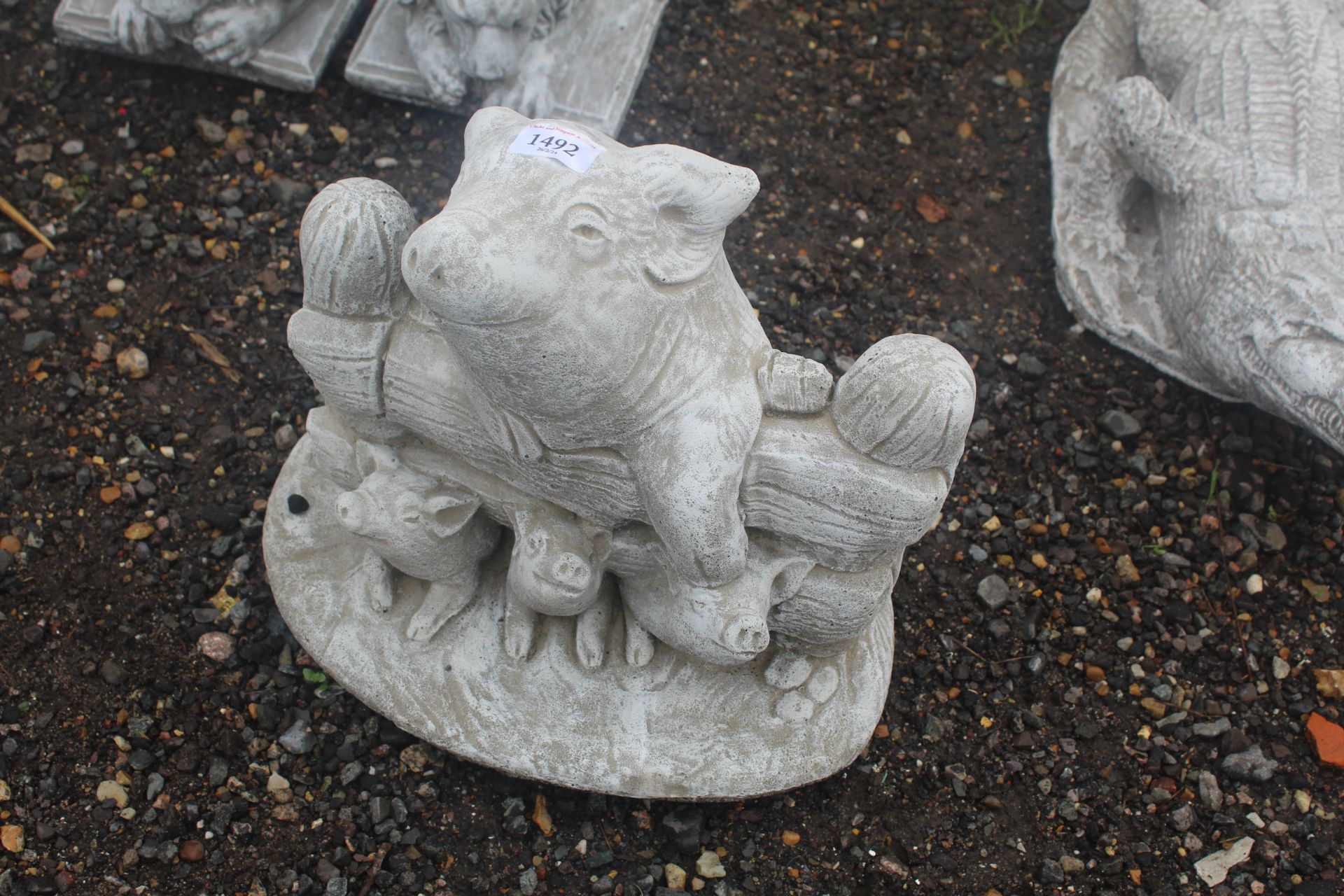 A cast concrete garden statue in the form of a mot