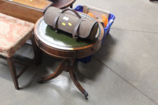 A circular drum table with inset leather top, rais