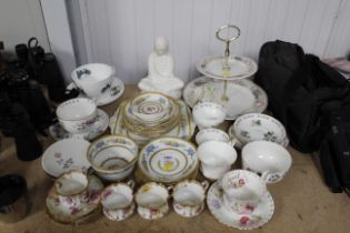 A floral patterned two tier cake stand, a small qu