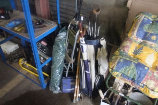 A vintage golf bag and quantity of clubs; an umbre