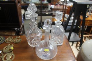 Three glass decanters and stoppers