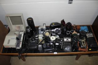 A large quantity of various camera equipment including a Nikkormat camera in fitted leather case,