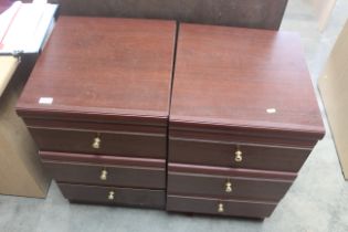 A pair of mahogany effect bedside chests fitted th