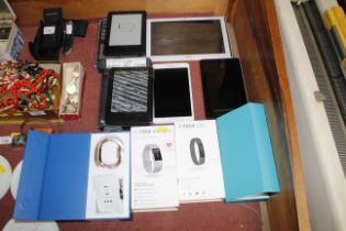 A Fitbit Charge 2 in rose gold with original box, a Fitbit Alter in original box, a Acer tablet,