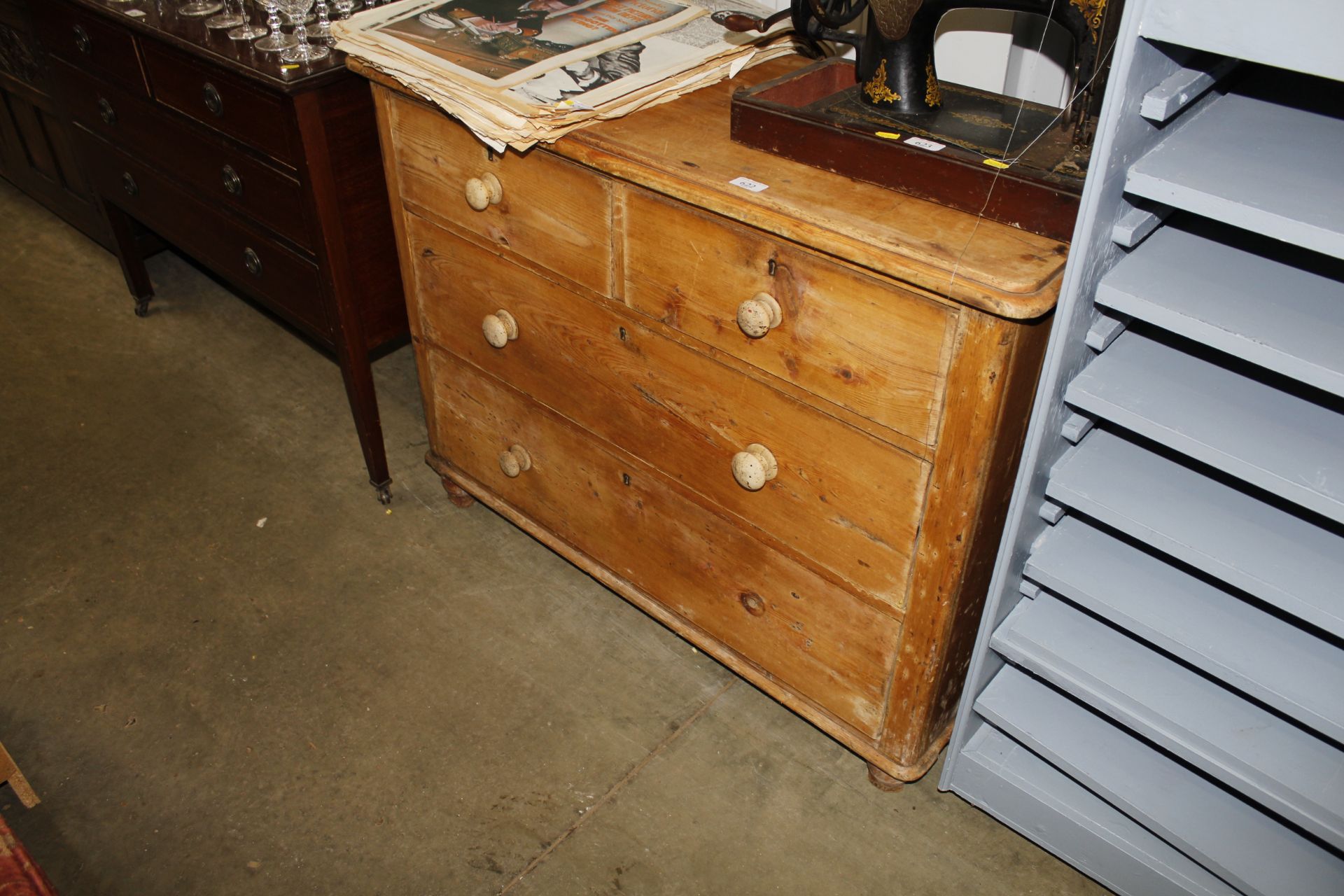 A pine chest of drawers fitted two short over two long (lacking one drawer knob)