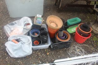 A quantity of various sized plastic plant pots etc