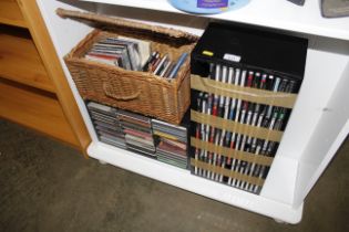 A quantity of various CD's, CD rack, wicker basket