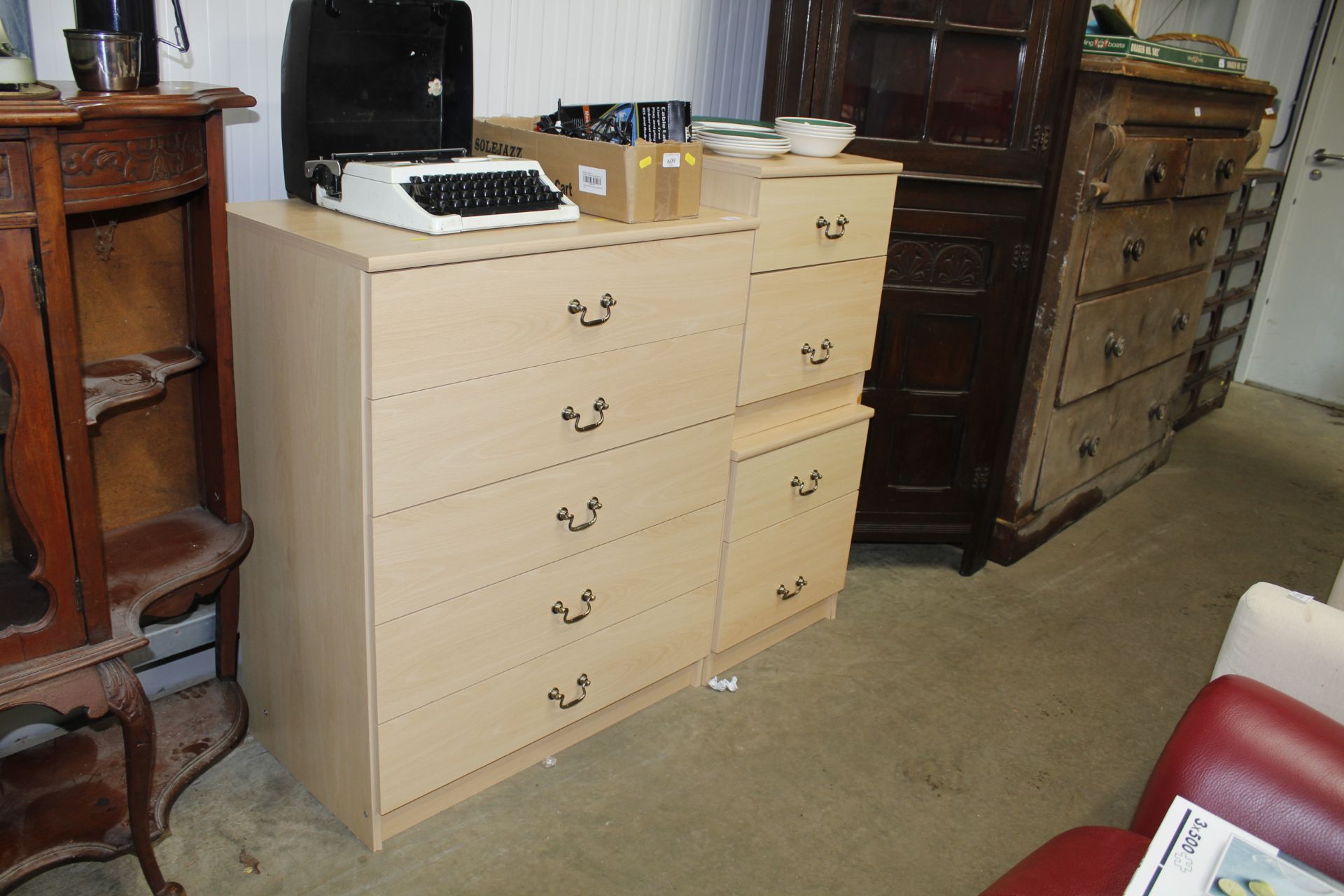 A modern chest of five drawers and a matching pair