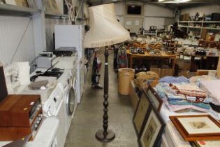 A turned wooden lamp with shade