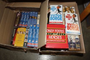 Two boxes of various VHS tapes to include a set of