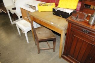 A leather topped oak writing table and an oak stick back chair