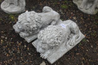 A pair of cast concrete garden statues in the form