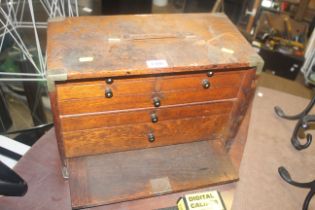 An oak and metal bound case of drawers comprising