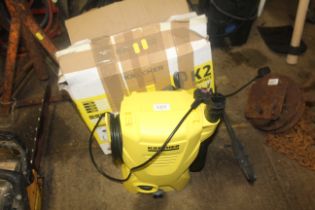 A Karcher K2 pressure washer with hose, lance and