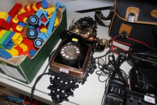 A vintage style rotary telephone mounted to cast i