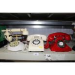 Three various rotary style telephones