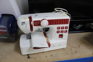 An E & R classic NT21 electric sewing machine with instruction guide