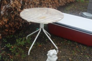 A circular plastic slatted garden table