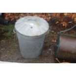 A galvanised dustbin with lid