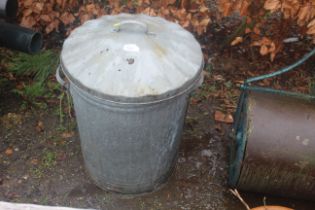 A galvanised dustbin with lid