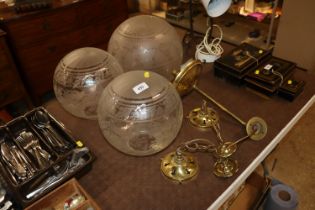 A pair of brass light fittings and another similar