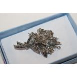 An unusual silver and marcasite brooch with centra