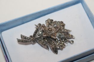 An unusual silver and marcasite brooch with centra