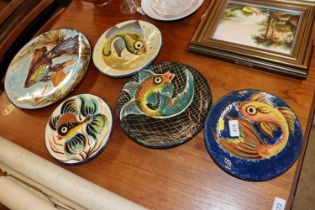 Four pottery fish decorated plates and a Spanish f