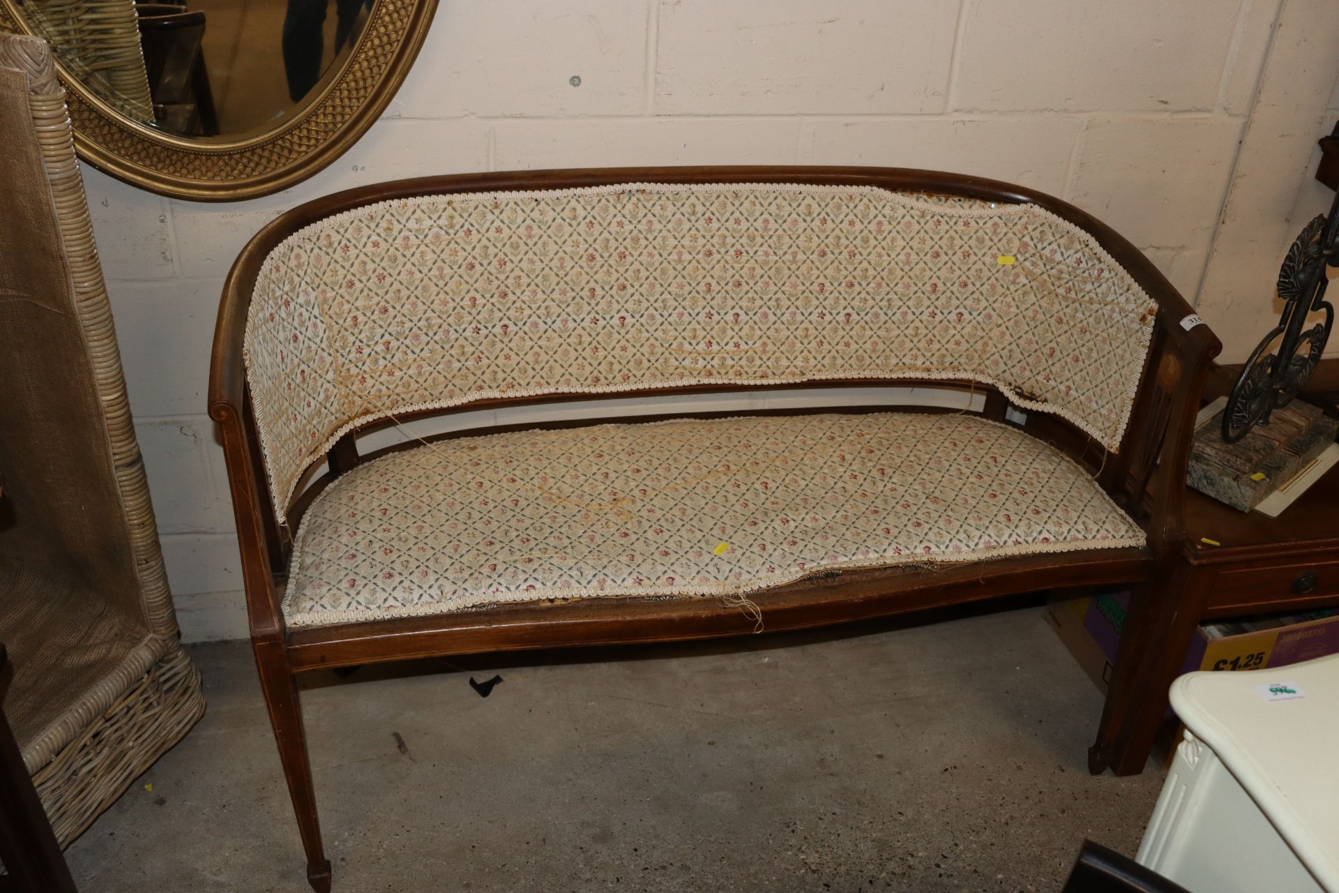 An Edwardian mahogany salon sofa raised on square