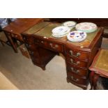 A reproduction mahogany pedestal writing desk