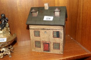 A tea caddy in the form of a house