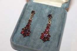 A pair of yellow metal and garnet set ear-ring's