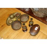 A brass inkwell; a pair of brass bowls; brass vase