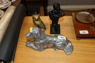 A cast model of a dog; a brass owl and a figure of