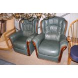 A pair of green leather upholstered armchairs