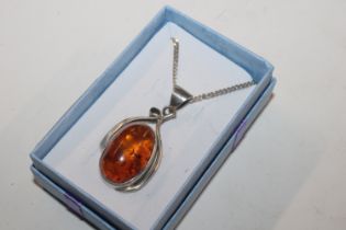 An Art Nouveau style Sterling silver and amber pen
