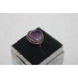 A white metal and amethyst set ring