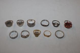 Eleven silver and white metal rings