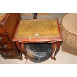 A nest of two leather topped occasional tables and